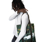 Person wearing a white hoodie and camouflage tote bag on a white background